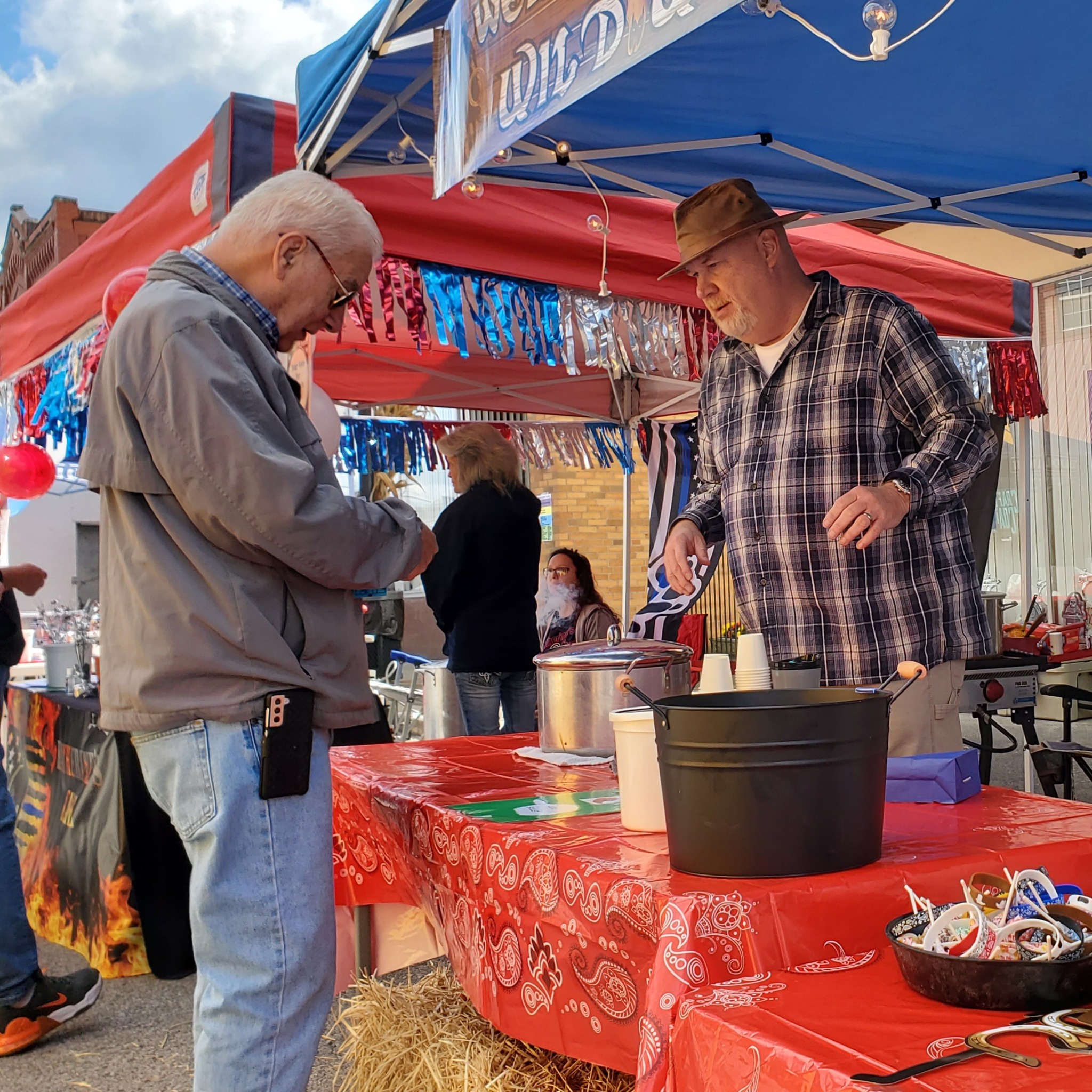 A visitor sampling chili at the Fall Y'all Chili Cook-Off